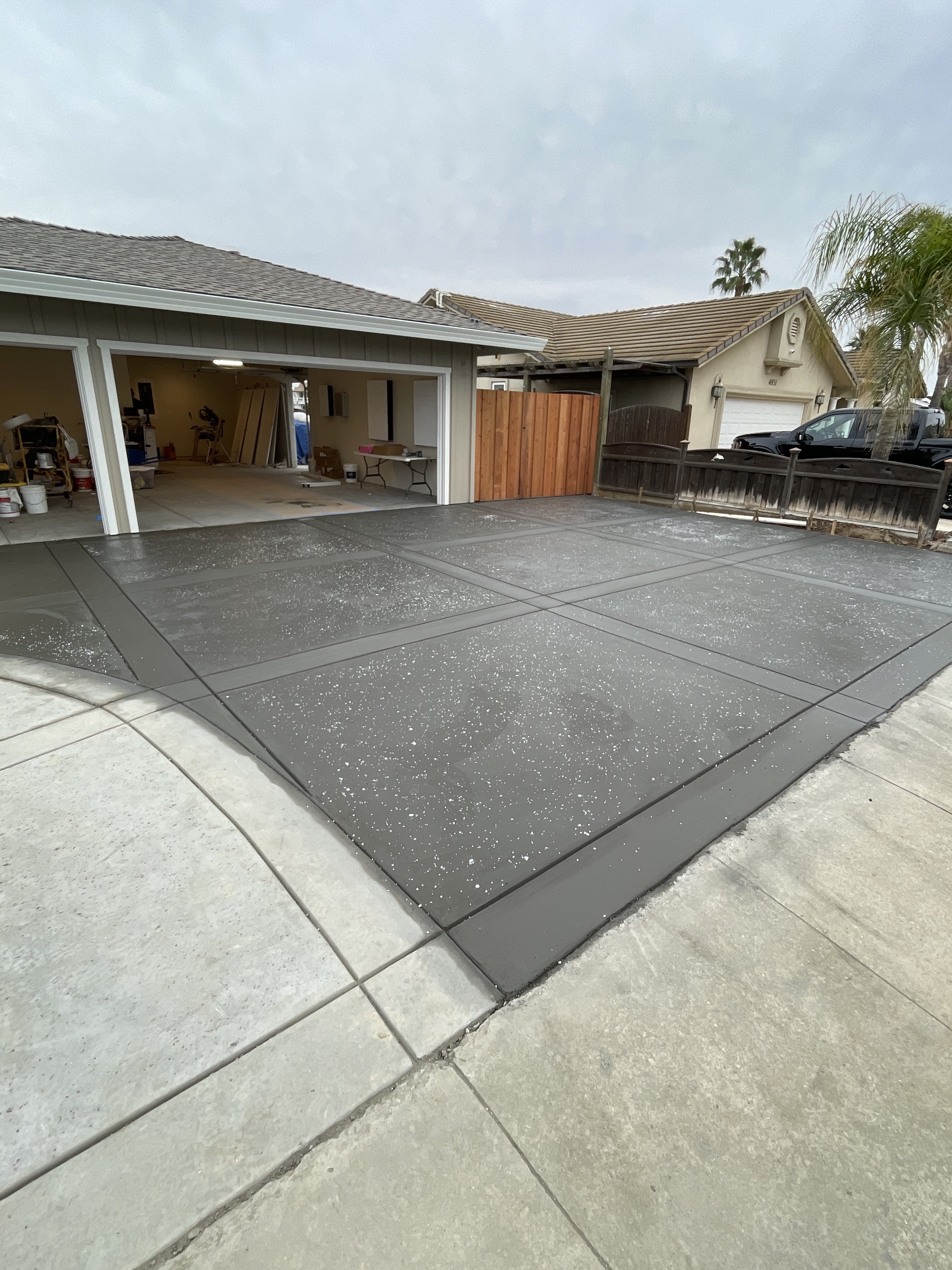 Epoxy coated driveway by BlackHawk Landscaping