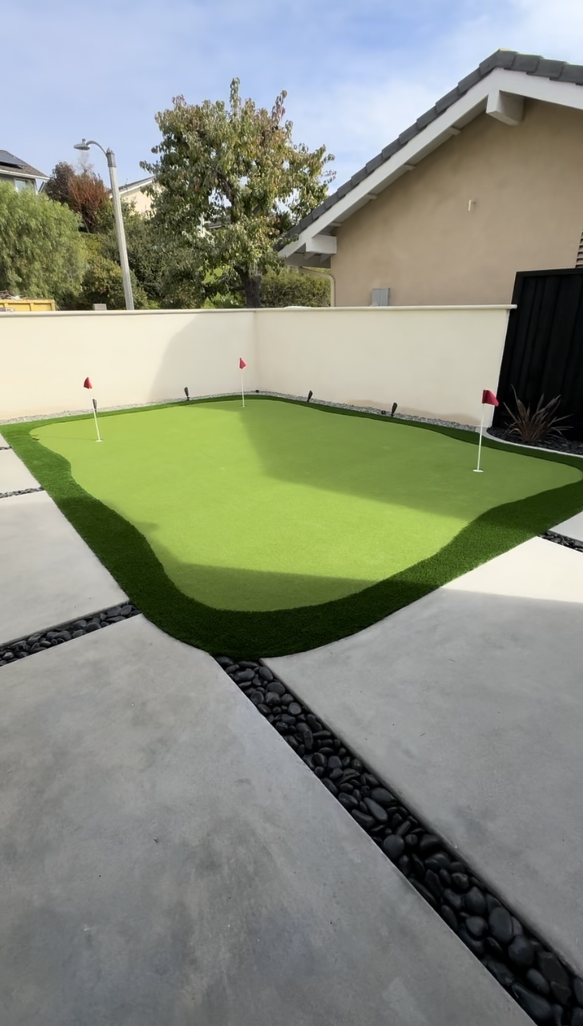 Custom putting green with artificial turf by BlackHawk Landscaping