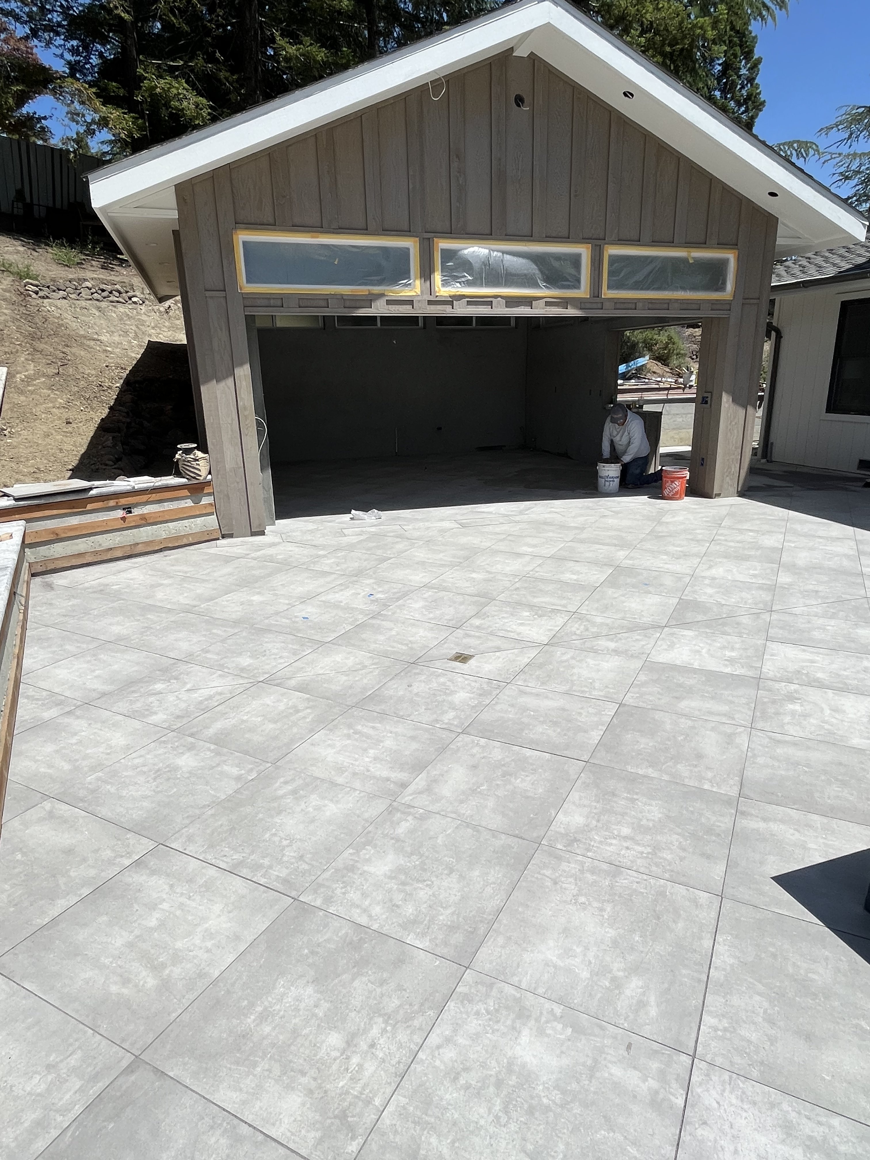 Large format tile driveway and patio by BlackHawk Landscaping